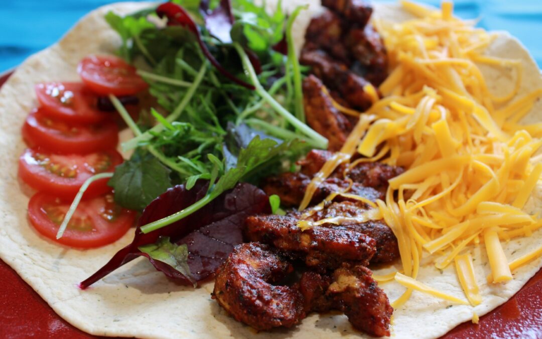 spiced chicken, salad and cheese in a tortilla wrap