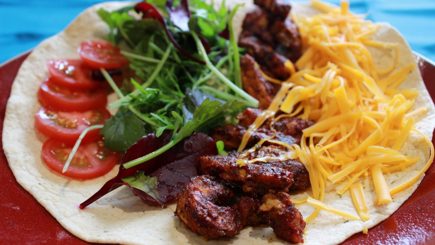 spiced chicken, salad and cheese in a tortilla wrap
